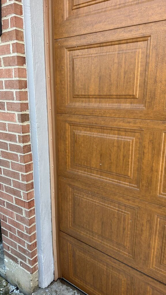 The new door stops have been installed on the frame and fit snugly against the door.